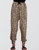 Roisin Adaptive Slouch Pants featuring a trendy leopard print pattern on bamboo fabric, with tapered legs, elastic cuffs, and drawstring waist. The pants showcase a relaxed fit silhouette against a light background, styled with black footwear.