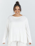 Essensual PJ Set featuring a soft white long-sleeve top with a relaxed boat neckline and flowy silhouette against a light background, showcasing comfortable sleepwear design perfect for a restful night's sleep.