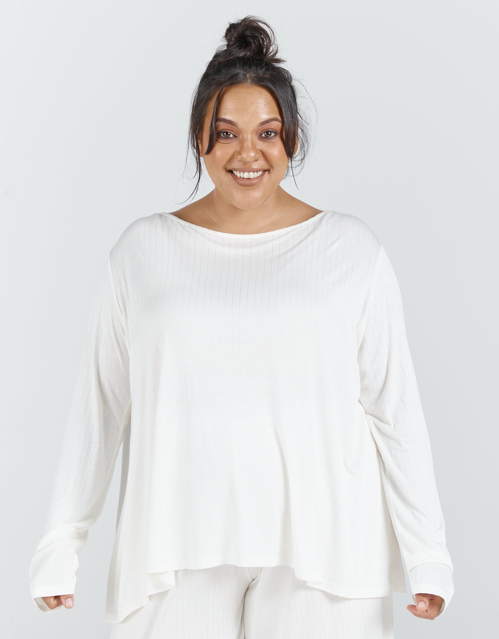 Essensual PJ Set featuring a soft white long-sleeve top with a relaxed boat neckline and flowy silhouette against a light background, showcasing comfortable sleepwear design perfect for a restful night's sleep.