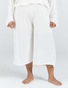 The Essensual PJ Set features comfortable wide-leg cropped pants in crisp white, showcasing a relaxed fit and flowing silhouette perfect for lounging. The sleepwear bottoms are shown against a light background, highlighting their elegant simplicity and premium comfort design.