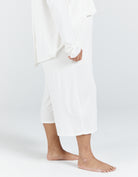 Essensual PJ Set - Pure white cotton pajama set with cropped pants and loose-fitting design, showcasing comfortable sleepwear with a minimalist aesthetic and relaxed silhouette against a light background