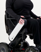 Maggie Thermal Top shown on a person seated in a power wheelchair, wearing all black attire. The close-up view highlights the top's comfortable fit and long sleeves, demonstrating its adaptive design for wheelchair users.