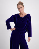 Emma Boat Neck Leaf Back Top in luxurious cobalt blue velvet, featuring an elegant draped neckline, three-quarter length sleeves with split cuffs, and a sophisticated leaf design on the back, photographed against a light background.