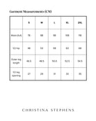 Size chart for Lindsay Seated Board Shorts displaying measurements in centimeters. Table shows waist, hip, outer leg length, and leg opening measurements for sizes S through 2XL, with Christina Stephens branding below.