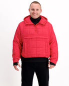 The Elly Universal Puffer Jacket in vibrant red features a pullover design with front kangaroo pocket, hood, and quilted pattern. The adaptive jacket has a relaxed fit with ribbed cuffs, shown against white background, demonstrating its practical and stylish design for wheelchair users.