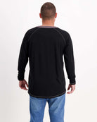 Sir Lord Raglan T-Shirt shown from back view, featuring classic black long sleeves with contrasting grey trim around neck and cuffs, worn with blue jeans against white background, displaying comfortable A-line silhouette and casual-smart styling.