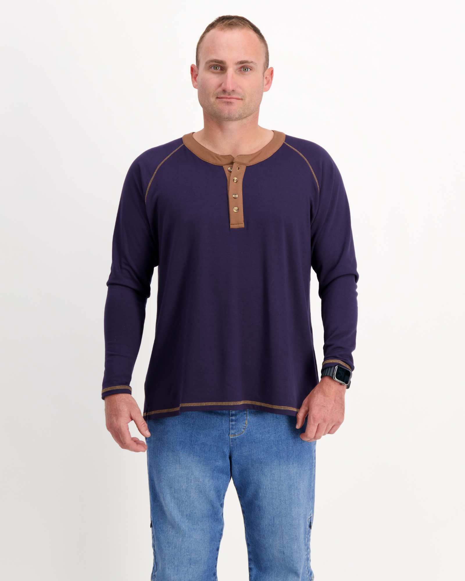 Sir Lord Raglan T-Shirt shown in navy blue with brown henley collar and contrast stitching, styled on a model with blue jeans. Long sleeve classic A-line design features raglan sleeves and a three-button placket for casual sophistication.