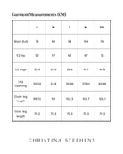 Size chart for Jessie Wide Leg Velvet Pants showing detailed measurements in centimeters across sizes S to 2XL, including waist, hip, thigh, leg opening, and length measurements. Christina Stephens brand logo displayed below.