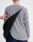 Karni Glitter Top shown from back view, featuring innovative leaf-back design with diagonal opening. Sparkly silver-grey metallic fabric contrasts with black underlayer, demonstrating adaptive wear functionality while maintaining elegant evening wear aesthetic.