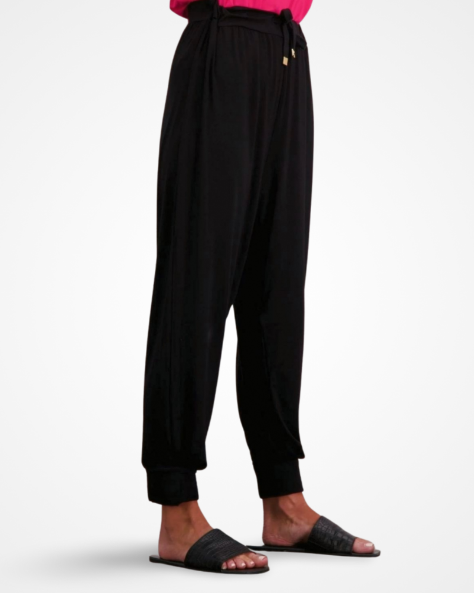 Roisin Adaptive Slouch Pants shown in elegant black bamboo fabric with tapered legs, elastic waistband, and drawstring detail, styled with black slides, demonstrating the relaxed fit and Smart Access design features against a white background