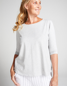 3/4 Sleeve Leaf Back T-Shirt in soft white fabric shown on model against light grey background, featuring a classic round neckline and comfortable, relaxed fit. Elegant casual design perfect for everyday wear.