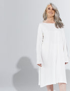 Essensual PJ Dress in crisp white, featuring a relaxed fit with long sleeves and knee-length hem. Elegant sleepwear design shown against a light gray background, highlighting the comfortable, flowing silhouette perfect for restful nights.