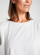 Close-up view of Short Sleeve Leaf Back T-Shirt in crisp white, featuring a classic round neckline and comfortable relaxed fit, showcasing the soft fabric texture and casual elegant design