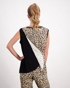 Lauren Sleeveless Physio Top shown from the back, featuring a unique diagonal design with black, white, and leopard print panels. The sleeveless cut showcases the distinctive leaf-inspired pattern across the upper back, perfect for athletic or casual wear.